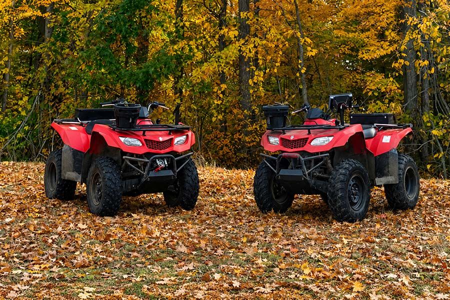 A pair of red all terrain vehicles